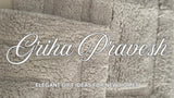 Folded premium white cotton towel set and a soft grey bath rug styled as griha pravesh housewarming gifts