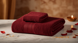 Willow & Fern burgundy and embroidered cotton towel sets styled as a premium Diwali gift with warm festive lighting