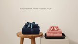 Willow & Fern folded cotton towel sets in sage green, navy blue, soft pink and silver grey styled with a matching bath rug to show 2026 bathroom colour trends