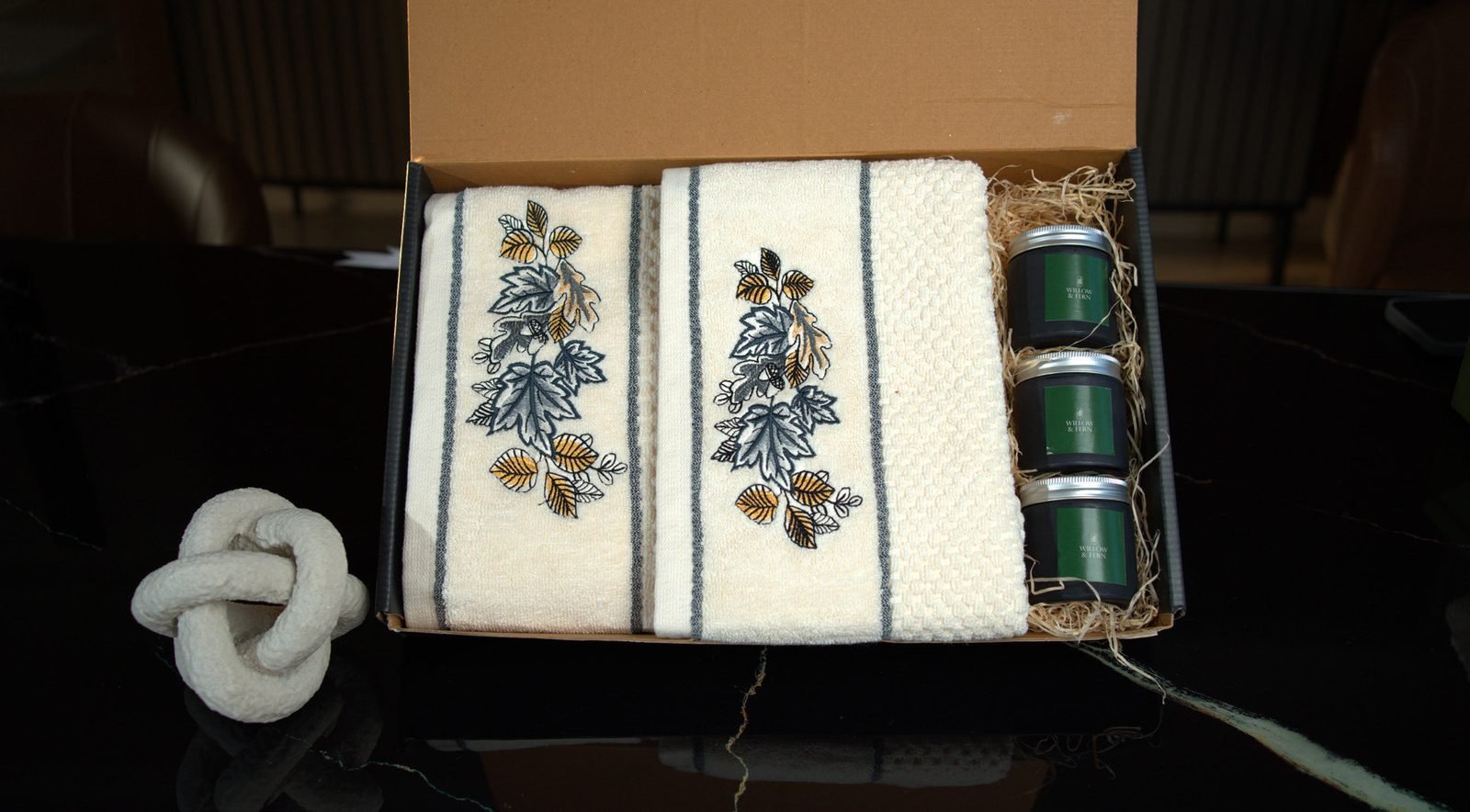 Corrugate gift box with embroidered towels and candles